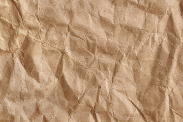 Wall Mural - Crumpled rough brown creased wrapping paper. Abstract paper texture background with copy space.