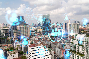 Social media icons hologram over panorama city view of Bangkok, Asia. The concept of people networking and connections. Double exposure.