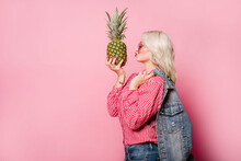 Blond Happy Woman With Pineapple Posing On Color Background