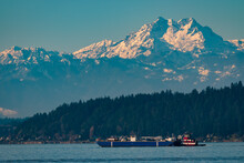 Snow Capped Olympic Mountains With Foreground Barge And Tugboat