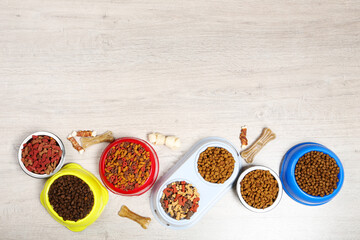 Wall Mural - Dry pet food in bowls with bones on the floor