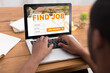 © Prostock-studio - Black guy using laptop with job search engine on screen