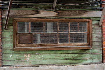 a narrow window with a wooden frame