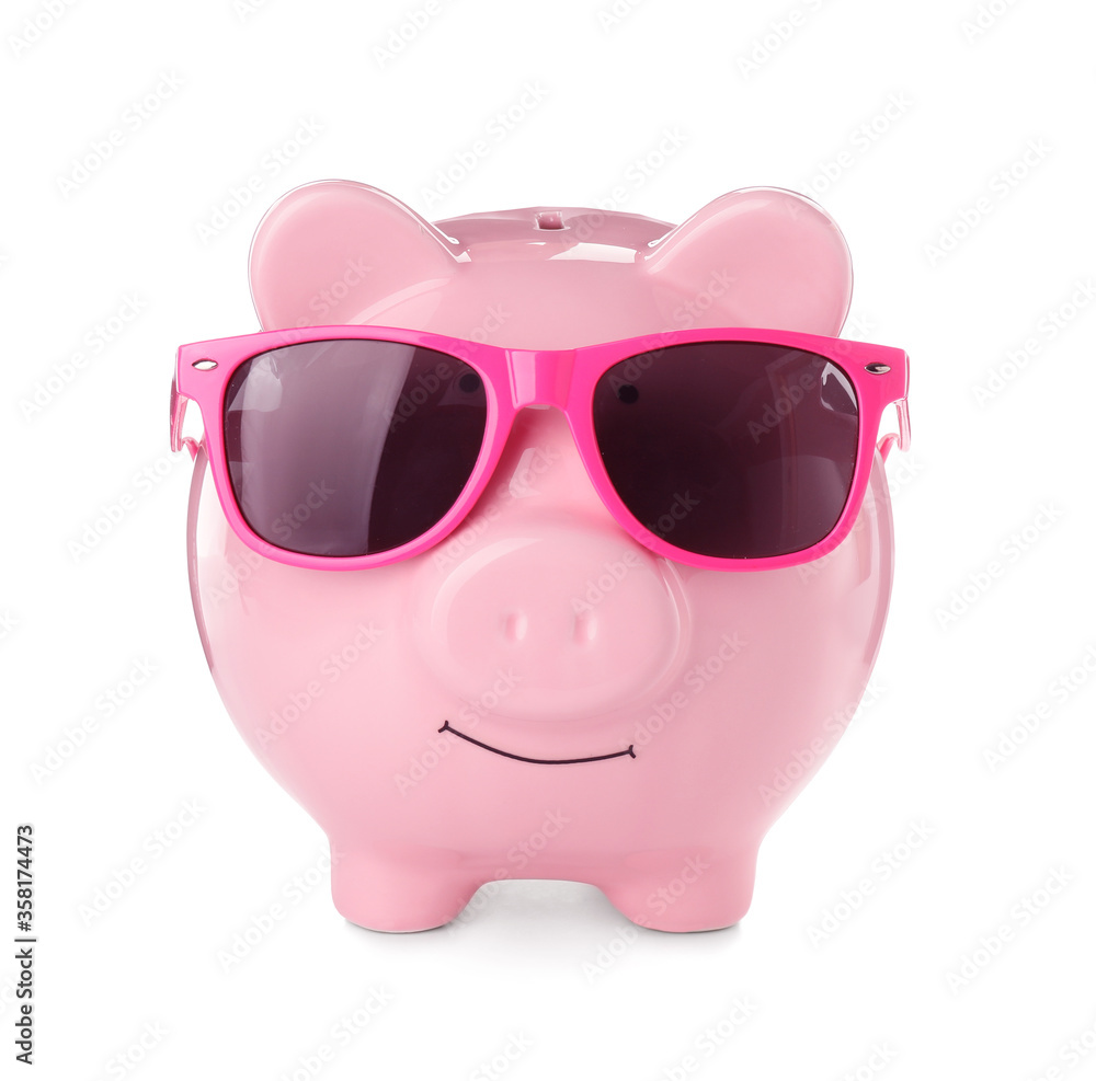Piggy bank with sunglasses on white background