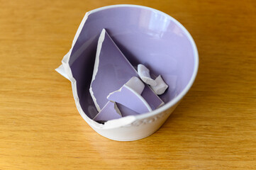 Broken ceramic mug with purple inside.