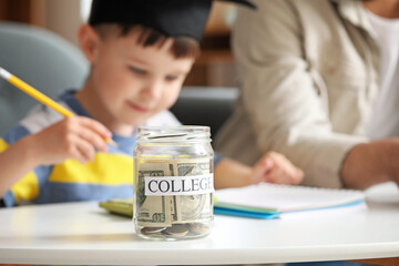 Sticker - Jar with savings for education on table at home