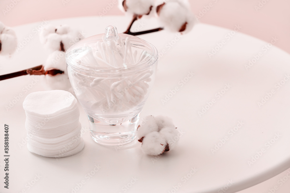 Cotton cosmetic pads and swabs on table