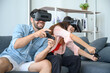 © Pataradon - Couple lovers enjoy  playing VR game together at home.