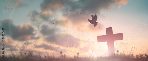 Cuadros en Lienzo Silhouette jesus christ crucifix on cross on calvary sunset background concept for good friday he is risen in easter day, good friday worship in God, Christian praying in holy spirit religious