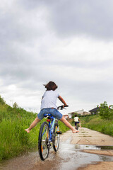 Poster - Child, boy, riding bike in muddy puddle, summer time