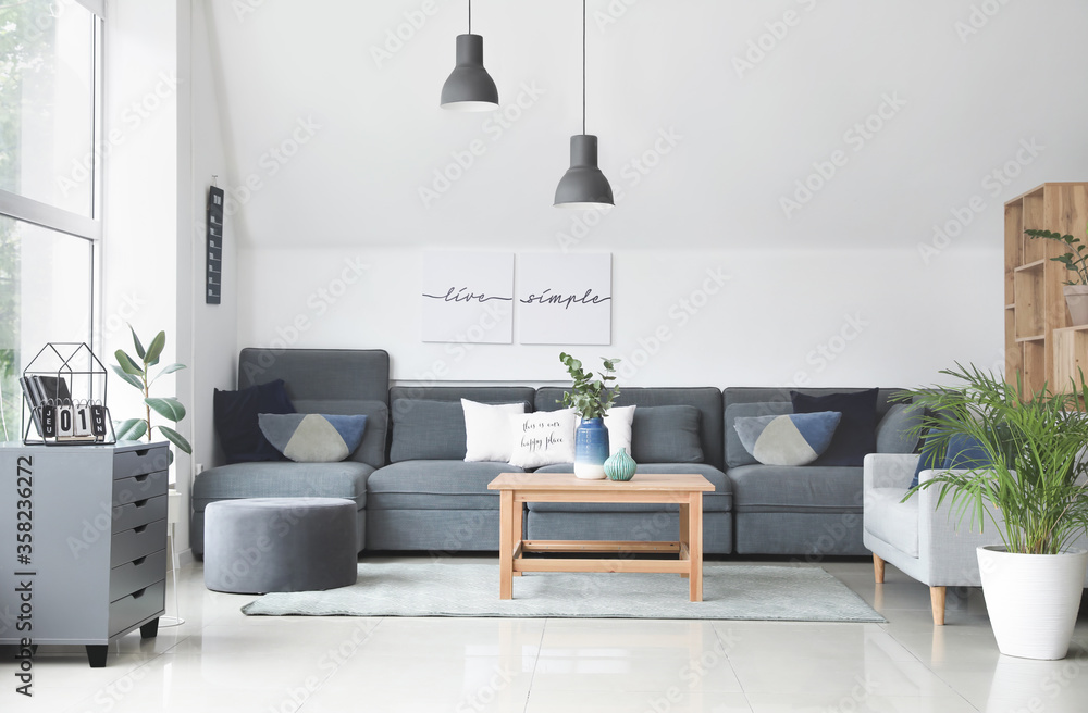 Stylish interior of living room with comfortable sofas and table