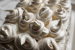 © Анна Иванова - Cream dessert of airy Italian meringue. Whipped egg whites with hot sugar syrup. Light delicate cake cream in the form of a twisted peak on the top of the head in a spiral