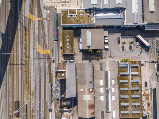 Wall Mural - Aerial view of industrial logistic center for distribution of freight. Large industry building with roof structure from above.