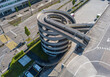 Aerial view of rooftop parking ramp. Spiral ramp leading cars to parking lot on the top of a building.