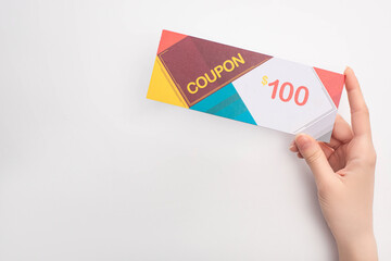 Wall Mural - Cropped view of woman holding coupon with 100 dollars sign on white background