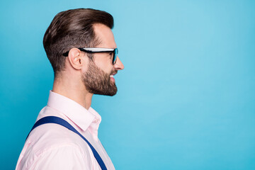 Wall Mural - Closeup profile photo of handsome business man successful young chief boss worker look empty space beaming smile wear specs pink shirt suspenders isolated pastel blue color background