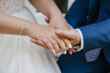 © alexkoral - groom gently holds the bride's hand at the wedding ceremony