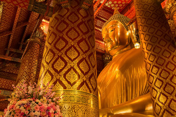 Wall Mural - Ayutthaya, Thailand -July, 31, 2018 : Giant golden Buddha in Wat Phanan Choeng, Buddha statue is called Luang Pho Tho of Ayutthaya, Thailand