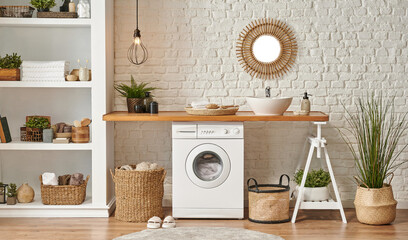 washing machine in the laundry room, wooden table and shelf style, sink lamp mirror and wicker baske