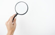 © studioprodakshn - image of spying woman's hand holding magnifying glass on isolated white background