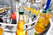apple juice in glass bottles in a factory for the food industry - bottling and transport