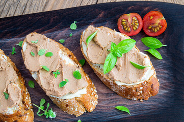 sandwiches with butter and liver pate decorated with herbs