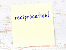 Yellow Sticky Note On Wooden Wall With Handwritten Word Reciprocation