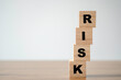 © Dilok - Stacking of wooden which print screen risk wording on the table with copy space. risk management concept.
