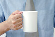 © photobuay - Mug mockup. businessman's hands holding mug with blank space for your text or promotional content.
