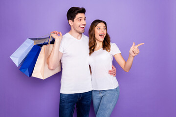 Poster - Photo pretty lady guy shocked low prices couple good mood go shopping hold many store package spree direct finger empty space wear casual t-shirts jeans isolated purple color background