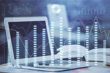 Forex graph hologram on table with computer background. Double exposure. Concept of financial markets.