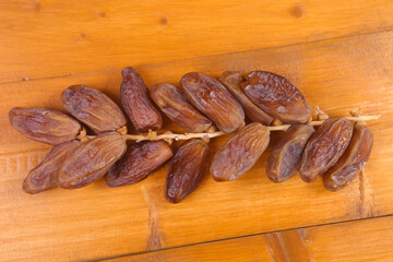 dried dates isolated on a wooden table