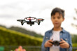 © amfer75 - Close up of child flying drone in the park