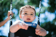 Baby In Swing In A Playground 
