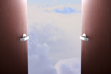 Wall Mural - Sale of airline tickets. Opening the borders of countries, the beginning of travel, the removal of restrictions. Doors swing open overlooking fluffy clouds in the blue sky