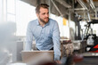 © Westend61 - Young businessman with laptop in a factory