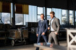 © Westend61 - Two smiling businessmen walking in a factory