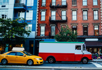 Van automobile on avenue in district with vintage buildings transporting goods for delivery shipping service company, urban setting with old historic architecture and traffic on road in district