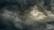Gray Gloomy Sky Before The Storm With Unusual Bizarre Patterns Of Dense Cumulus Clouds And Back Light. Panoramic View. Artistic Picture For Mystical Design Or Decoration