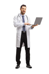 Poster - Male doctor standing and using a laptop computer