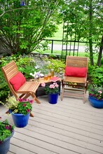Outdoor Patio Seating In Beautiful Tranquil Backyard Sanctuary With Beautiful Landscaping For Mindful Relaxation On A Warm Summer Afternoon During Quarantine Stay At Home Vacation