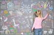 © New Africa - Little girl drawing with colorful chalk on gray wall