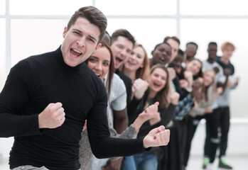 group of happy young people standing behind each other