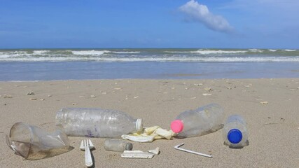 Poster - Picking up plastic trash from beach. Plastic bottles, bags, straws and cups litter a pristine beach. Environmental clean up