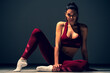 © Artem - The beautiful young woman in sportswear is sitting on the floor