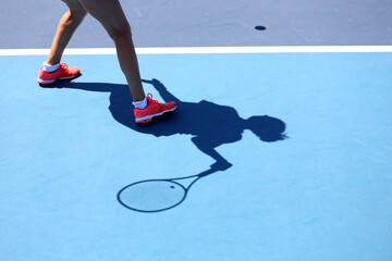 shadow of a female tennis player 