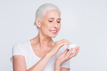 Sticker - Close up photo of lovely lady with top-knot holding jar with nourishment wearing white trendy stylish t-shirt isolated over white background