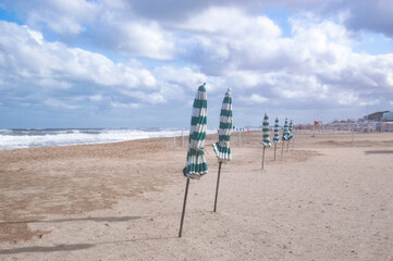 Wall Mural - Closed umbrellas on the beach of pinamar, Buenos Aires, Argentina