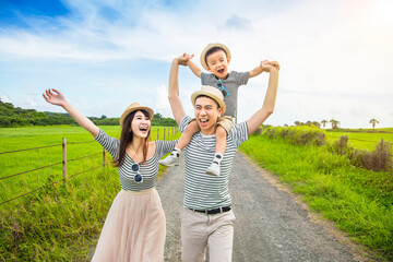 Wall Mural - happy family having fun and walking on the country road