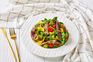 Wall Mural - Vegetables with sliced beef steak on a white plate